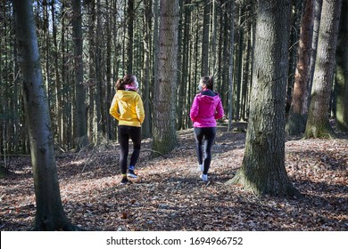 young women in anti-virus masks walking in the forest - during the coronavirus epidemic, most countries banned entry to national parks and forests                      