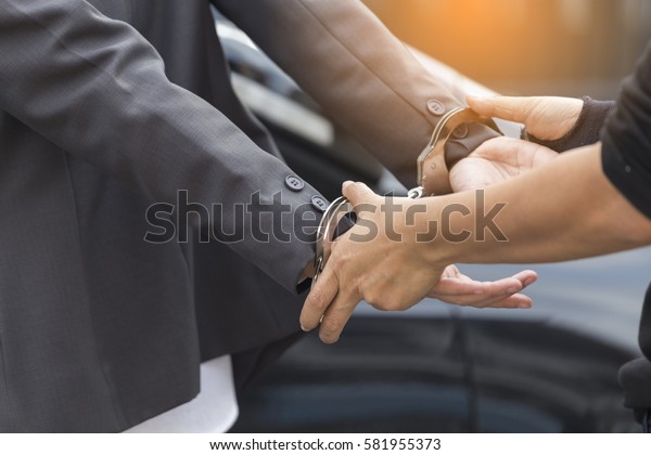 Young women
arrested and with handcuffs,business woman in handcuffs and woman
hand offering key solving business ideas concept,Police law steel
handcuffs arrest crime human
hand.