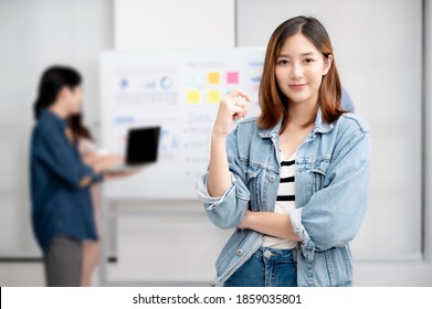 Young Women Asian Confidence Team Leader Business Looking Camera And Smile In Modern Office Room With Blurred Background Group People