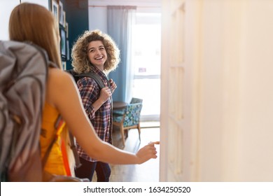 Young Women With Backpacks Arriving To A Youth Hostel 