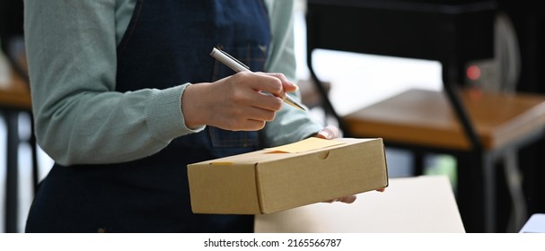 Young Women Business Owner Working At Home Office With Packing Box. E-commerce, Online Selling Concept