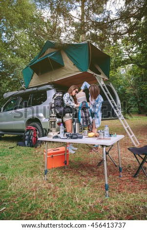 Similar – Image, Stock Photo Women resting and talking lying in tent over car