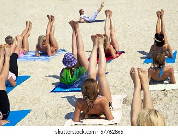 Young women doing fitness exercise on a beach