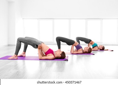 Young women doing yoga in gym
