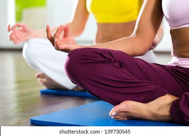 Young Women Doing Yoga And Meditation In Gym For Better Fitness, Caucasian And Latina People