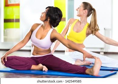 Young Women Doing Yoga And Meditation In Gym For Better Fitness, Caucasian And Latina People