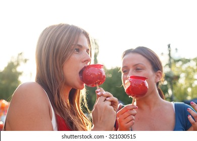 Young Women Eating Candy Apple