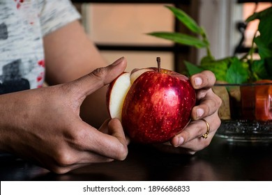 Young Women Eating Fresh Apple. Female Hand Cut Out Core From An Apple.