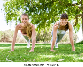 Young women exercising in the park - Shutterstock ID 764333440