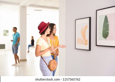 Young Women At Exhibition In Art Gallery