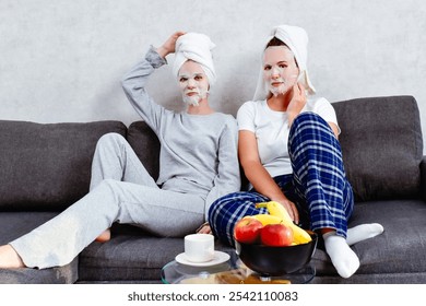 Young women friends enjoy self-care at home. A cozy moment that highlights the importance of taking care of oneself and friendship in a comfortable setting. - Powered by Shutterstock