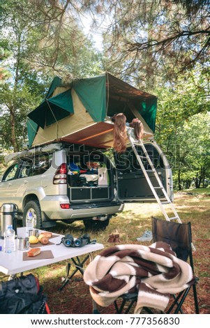 Image, Stock Photo Women resting and talking lying in tent over car