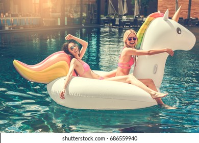Young women friends in the swimming pool fun - Powered by Shutterstock