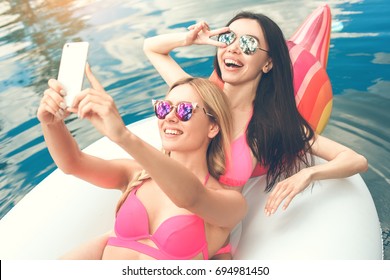 Young women friends in the swimming pool fun - Powered by Shutterstock