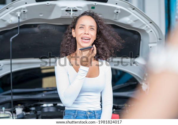 Young women are frustrated by the
car accident. Young charming girl talking on the
phone.