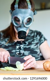 Young Women With Gas Mask Cuts A Onion