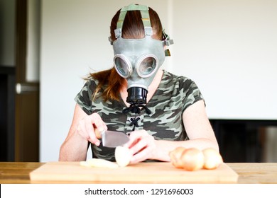 Young Women With Gas Mask Cuts A Onion