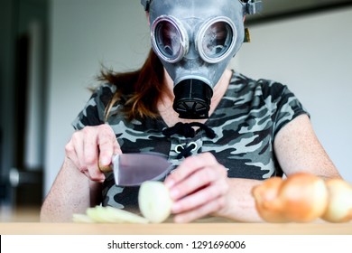 Young Women With Gas Mask Cuts A Onion