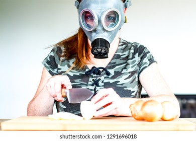 Young Women With Gas Mask Cuts A Onion