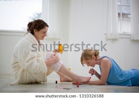 Similar – Carer wearing slippers to elderly female patient