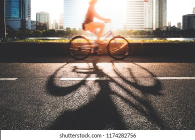 A young women going to work place by her bike in morning.