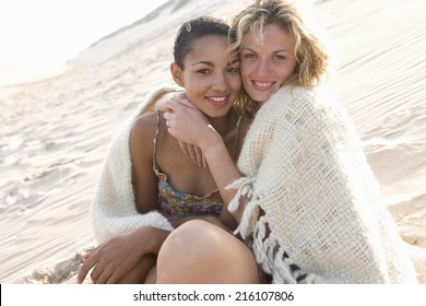 Young Women Hugging On Beach