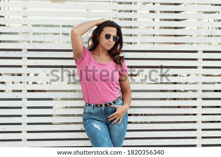 Similar – Woman with sunglasses looking at camera over garden fence