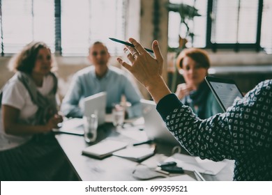 Young Women Listening To Speaker During Presentation In Creative Office. Successful Feminine Teamwork And Business Brainstorming Concept. Toned Image