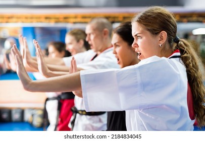 Young women mastering martial arts techniques for self-defense at practice in training room - Powered by Shutterstock