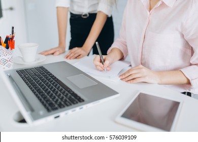 Young Women In Office Working Together On Desktop.