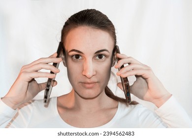 Young women on double mobile phone - Shutterstock ID 2394562483