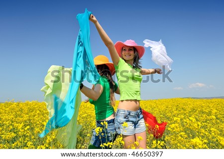 young women on field in summer