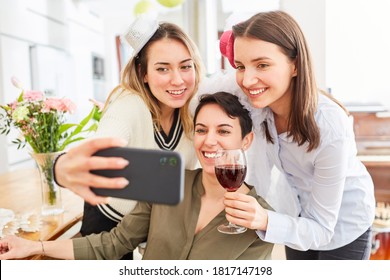 Young Women On Livestream On Smartphone Of Hen Party With Bride Before Wedding