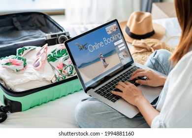 Young women planning summer vacation trip and searching information or booking hotel on laptop, Travel concept