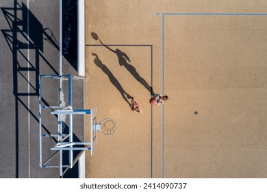 Young women playing basketball- aerial view - Powered by Shutterstock