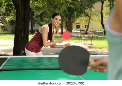 Young Women Playing Ping Pong In Park