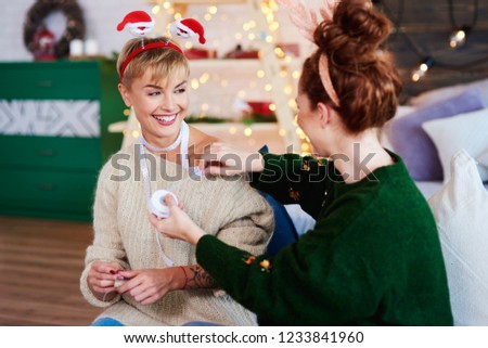 Young women preparing christmas gifts 