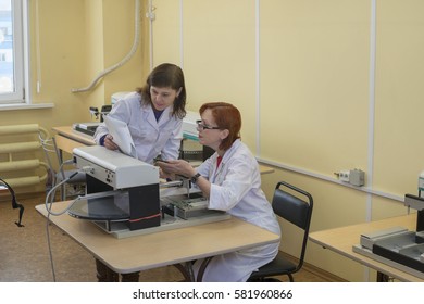 Young   women   professionals   working  with  boards  for  mounting  devices