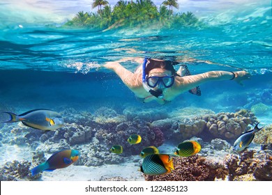 Young women at snorkeling in the tropical water