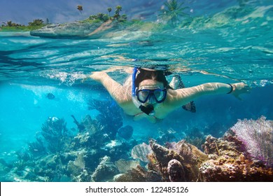 Young women at snorkeling in the tropical water