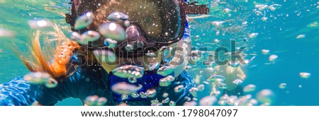 Young women at snorkeling in the tropical water BANNER, LONG FORMAT