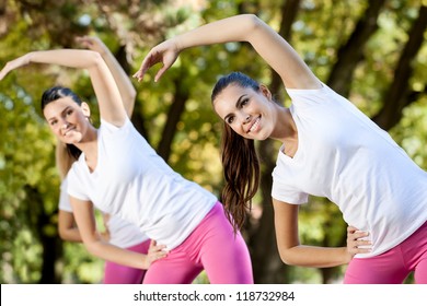 Young Women Stretching On Aerobics Class, Outdoor