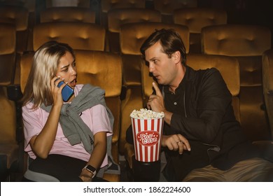 Young Women Talking On The Phone Interfering With Watching Movies Of Men Sitting Close To Each Other,this Man Had Admonished, For Her Lack Of Etiquette, To Stop Speaking.