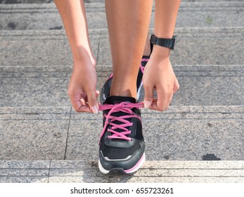 Young women tie the sholace prepare for jogging