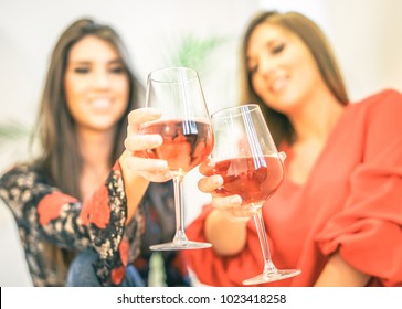 Young Women Toasting Glasses Of Rose Wine In Their Home - Happy Girls Enjoying Their Time Together Drinking Cocktails And Having Fun Laughing - Concept Of People, Youth Lifestyle - Focus On Top Glass