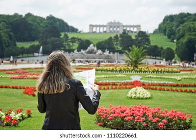 Young Women Tourists Expand Survey Map In Gloriette In The Schönbrunn Garden, Vienna, Austria