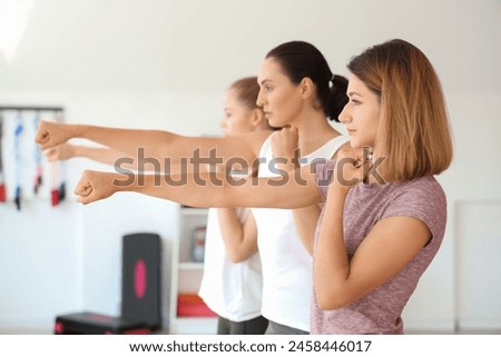 Young women training at self defense courses in gym