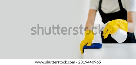 Young women use cleaning cloths and disinfectant sprays to wipe tables and mop floors in the house. cleaning staff cleaning maid
