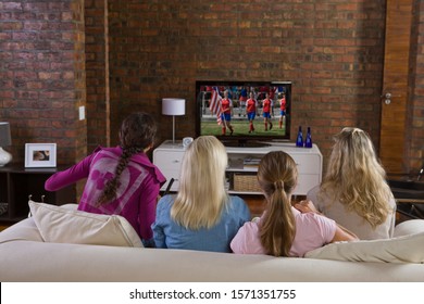 Young Women Watching Women's Soccer Game On TV