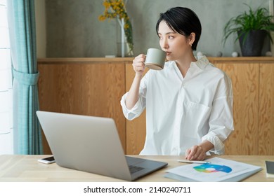 Young Women Who Work Remotely With Coffee